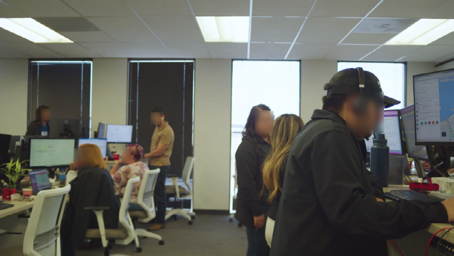 Figure 1: Redacted subjects sitting and standing at their workstations.