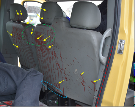 Figure 4: Blood Stains on the Back, Top, and Right Sides of the Driver’s Seat and Head Restraints, on the Back and Top of the Passenger Seat and Head Restraints and on the Rear of the Plastic Mask and the Tire of the Frame Between the Passenger and Rear Doors.