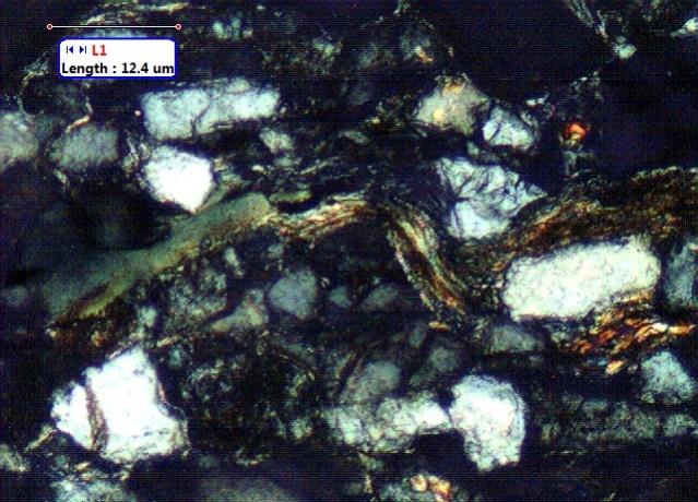 Figure 1: Thin section images of sandstone recovered from BH(A) (depth=3827-3837m) showing the presence of mica.