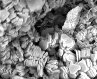 Figure 11: Thin section images of sandstone recovered from NH(B) (depth=3836-3839m) showing the presence of clay and chlorides.