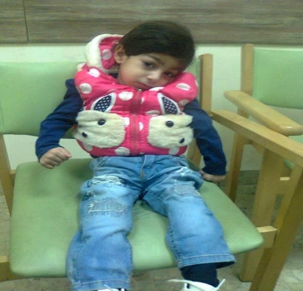 Figure 8: Patient-6 at about the age of three, he was unable to sit on a chair without slipping and couldn’t control or move his head when put in the sitting position.