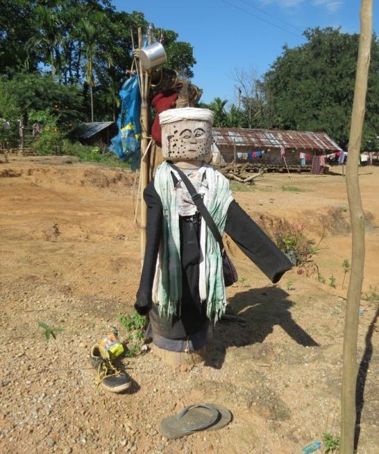 Figure 1: Kima post. Note the dress and ornaments placed on the statue, as well as food receptacles on a supporting post. Photo Credit: Tengnang D. Sangma
