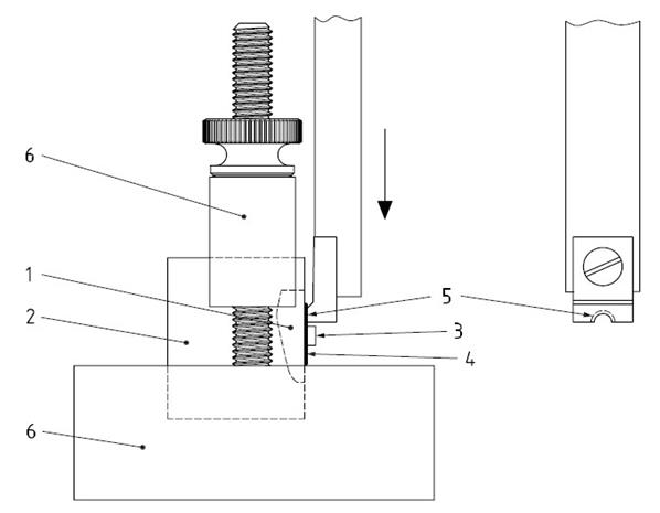 Figure 3: Bonding sample in test base clamp with notched-edge crosshead.