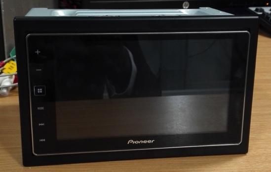 Figure 14: The Pioneer offers a number of connection ports at the rear that includes USB, HDMI and audio. This is to support a variety of functionality that it appears to offer Figure 15. Undoing a number of screws, loosening clips and finally detaching a ribbon cable can remove the inner unit from the outer casing. This exposes the PCB along with a 4GB SD card. This particular vehicle unit, being new, required data to be planted. In order to do so, an electronic power supply was used to provide the required power input. From there, a series of interactions were made with the device via Bluetooth using an Android handset. Figure 14: Pioneer SPH-DA120 (front view).