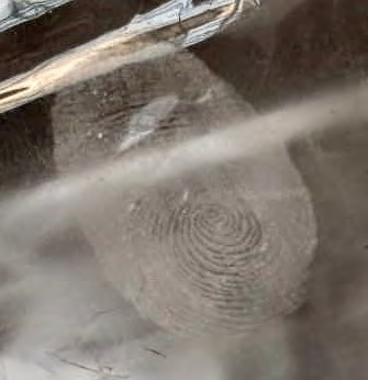 Figure 11: Development of Latent Fingerprint with the help of smoked grey salt powder on Non-Porous Plastic surface.