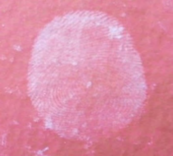 Figure 7: Development of Latent Fingerprint with the help of sugar powder on Porous Cardboard surface.