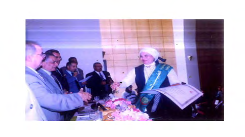 Figure 3: Dr. Montaser wearing the winner’s scarf receives the award of “Ideal Doctor” on Egyptian Doctor’s Day from the Minister of Health.
